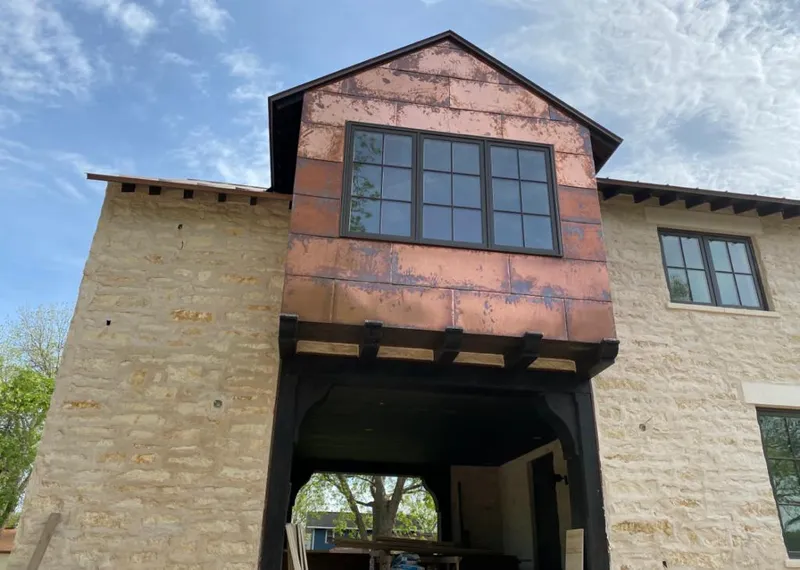 Copper metal panel facade on a stone building for Skylight Installation in Waukesha