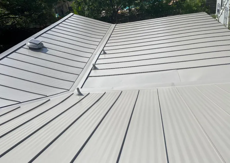 Solar attic fan installed on a metal roof for Roof Ventilation in Waukesha